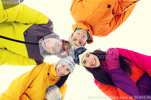 Image of happy friends in ski goggles outdoors