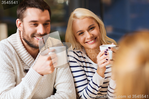 Image of happy couple meeting and drinking tea or coffee