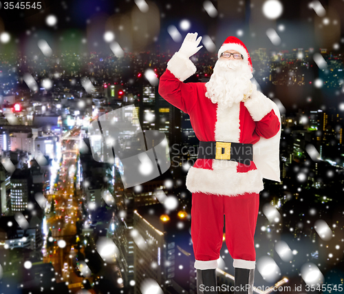 Image of man in costume of santa claus with bag