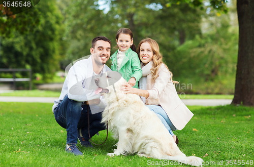 Image of happy family with labrador retriever dog in park