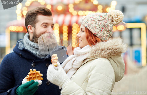 Image of happy couple walking in old town