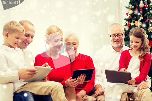 Image of smiling family with tablet pc computers at home