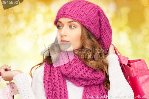 Image of young woman in winter clothes with shopping bags