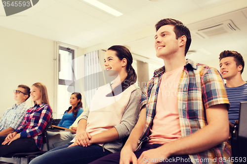 Image of group of smiling students in lecture hall