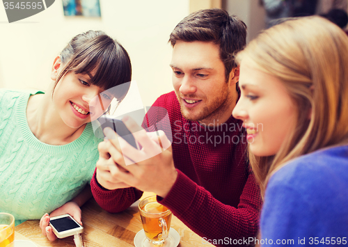 Image of group of friends with smartphones meeting at cafe