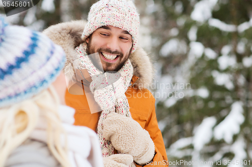 Image of happy friends or couple in winter forest