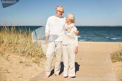 Image of happy senior couple talking outdoors