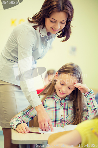 Image of group of school kids writing test in classroom