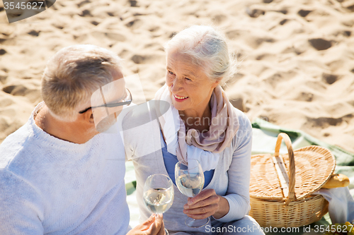 Image of happy senior couple talking on summer beach