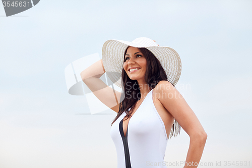 Image of happy young woman on beach