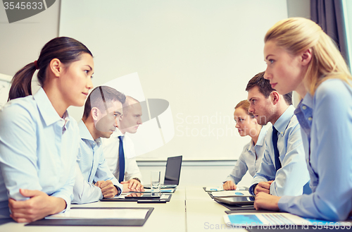 Image of smiling business people having conflict in office