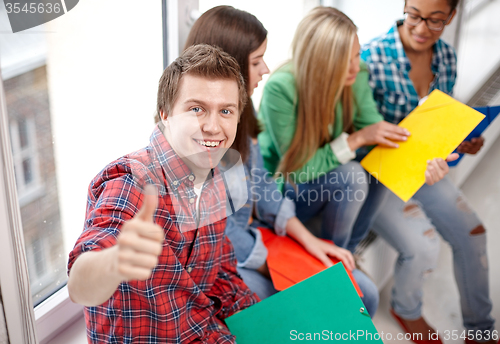 Image of group of happy students showing thumbs up