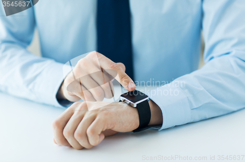 Image of close up of male hands setting smart watch