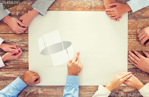 Image of close up of business team with paper at table