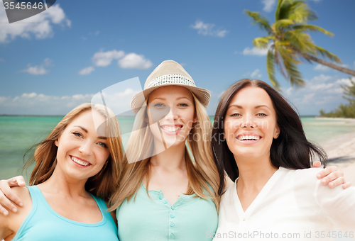 Image of group of happy young women over summer beach