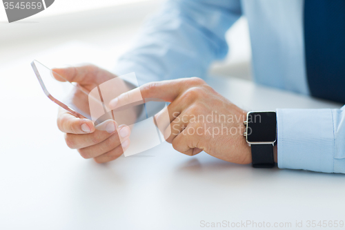 Image of close up of hands with smart phone and watch