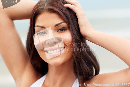 Image of happy young woman on beach