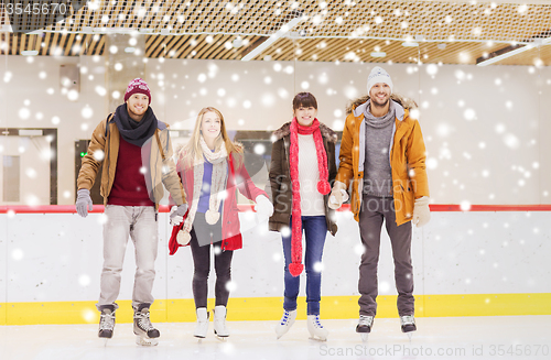 Image of happy friends on skating rink