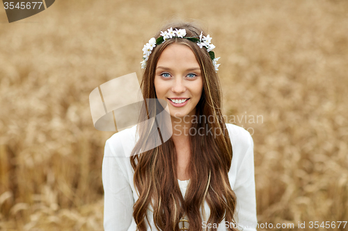 Image of smiling young hippie woman on cereal field