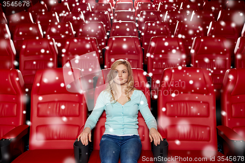 Image of young woman watching movie in theater