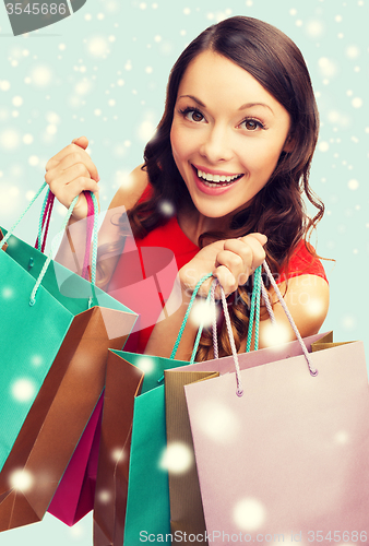 Image of woman in red dress with shopping bags