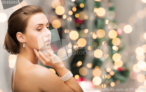 Image of beautiful woman with pearl earrings and bracelet