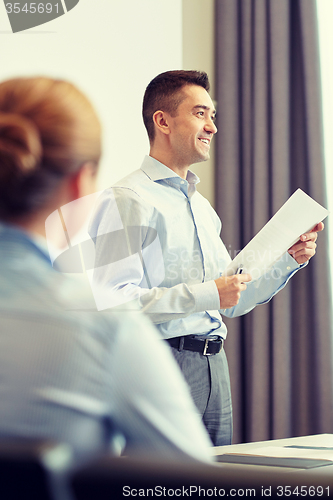 Image of smiling businesspeople meeting in office