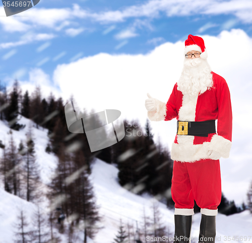 Image of man in costume of santa claus showing thumbs up
