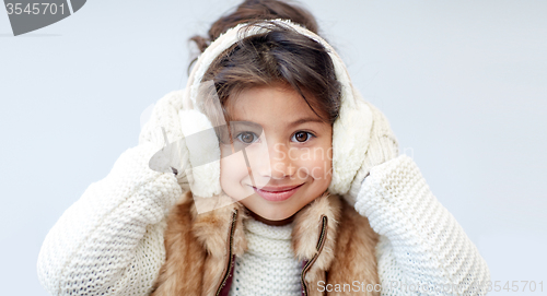 Image of happy little girl wearing earmuffs