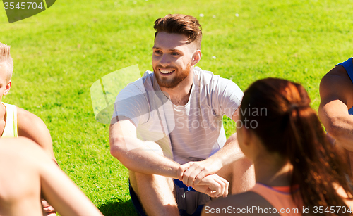 Image of group of happy friends or sportsmen outdoors