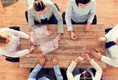 Image of close up of business team sitting at table