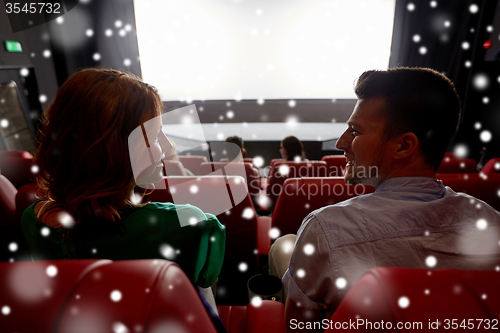 Image of happy friends or couple watching movie in theater