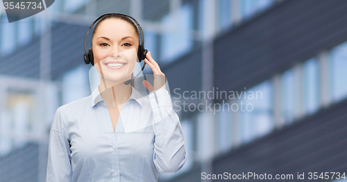 Image of helpline operator in headset over business center