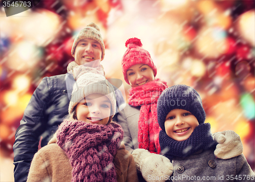 Image of happy family in winter clothes outdoors