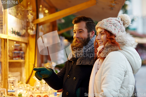 Image of happy couple walking outdoors