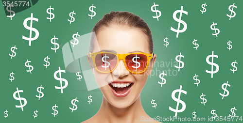 Image of happy woman in shades with dollar currency sings