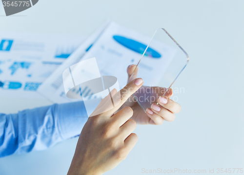 Image of close up of woman with transparent smartphone