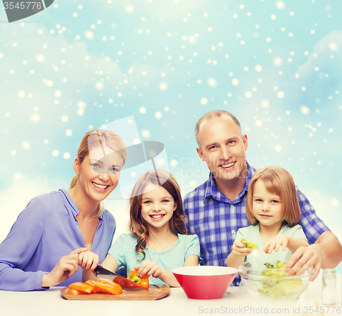 Image of happy family with two kids making dinner at home