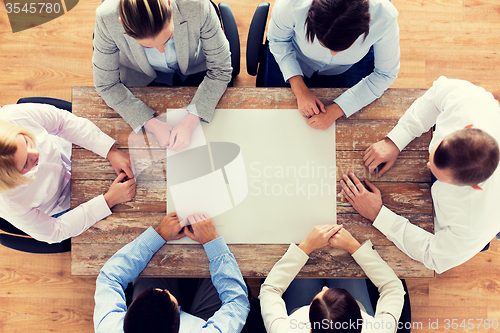 Image of close up of business team sitting at table