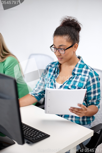 Image of happy high school students in computer class