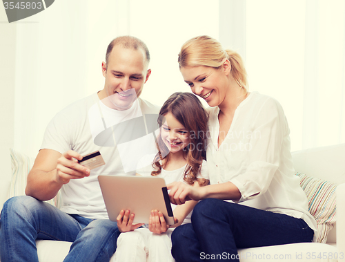 Image of parents and girl with tablet pc and credit card