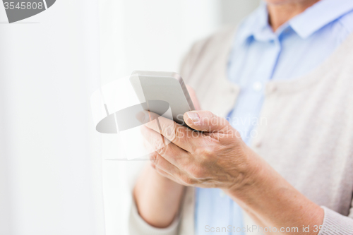 Image of close up of senior woman with smartphone texting