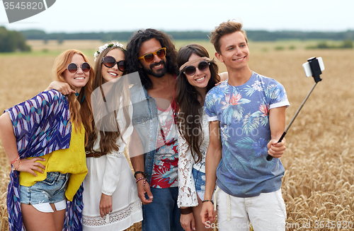 Image of hippie friends with smartphone on selfie stick