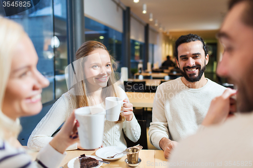 Image of happy friends meeting and drinking tea or coffee