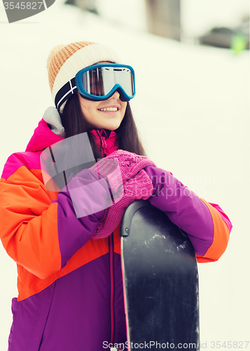 Image of happy young woman with snowboard outdoors