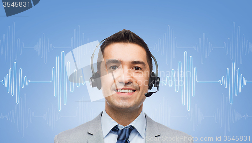 Image of businessman in headset over sound wave or diagram