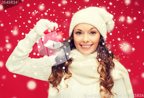 Image of smiling woman in mittens and hat with jingle bells