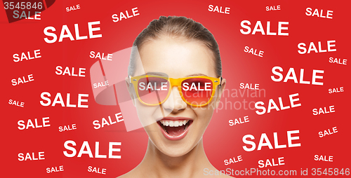 Image of happy teenage girl in shades with sale signs