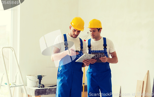 Image of builders with tablet pc and equipment indoors