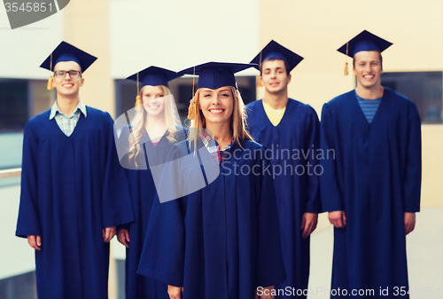Image of group of smiling students in mortarboards